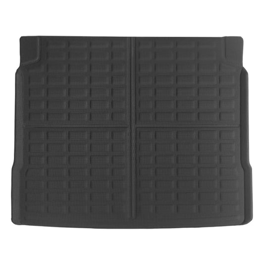 A black rubber car trunk liner with a grid-like textured pattern, shown flat against a white background.