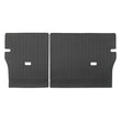 A pair of black rubber car trunk floor mats with a textured, ribbed pattern and cutouts, displayed side-by-side on a white background.